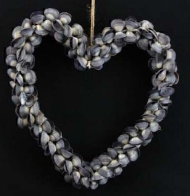 Indigo heart shaped shell wreath by Gisela Graham. This Heart shaped wreath by the designer Gisela Graham is made from lots of small mussel shells and would make a great decorative addition of a beach or sea themed bathroom. Size 26x28x4cm.